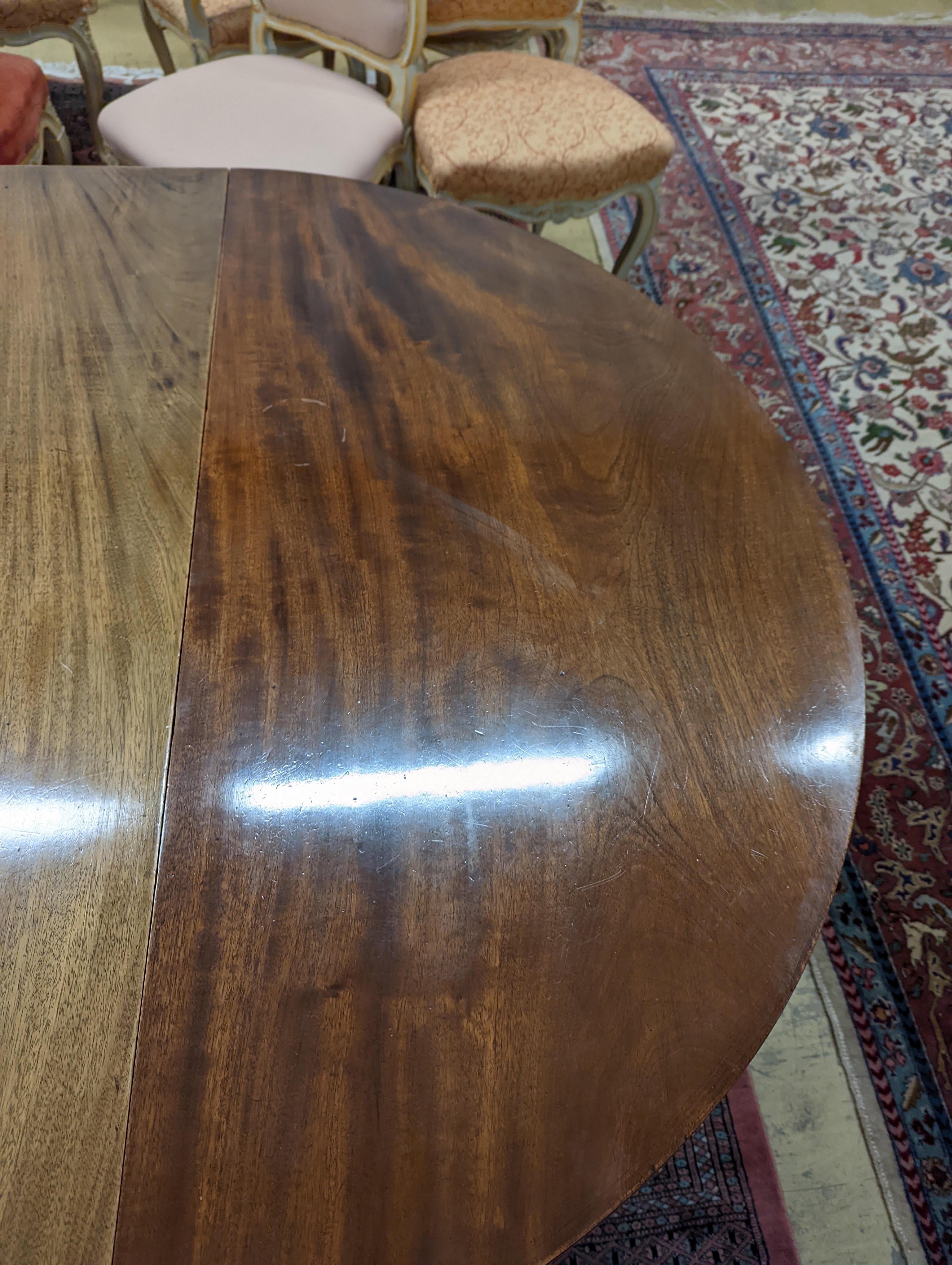 A George III mahogany D end extending dining table, with drop flap central section, length 240cm extended, width 120cm, height 76cm